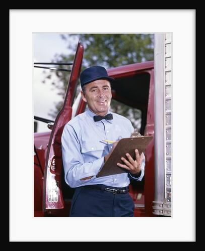 1950s 1960s Repairman In Uniform Holding Clipboard Standing In Open Door Of Truck Cab by Anonymous