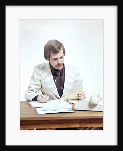 1970s Business Man At Desk Handling Paperwork Office Telephone by Anonymous