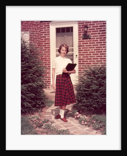 1950s Teenage Girl Holding School Books Walking Down Flagstone Walk by Anonymous