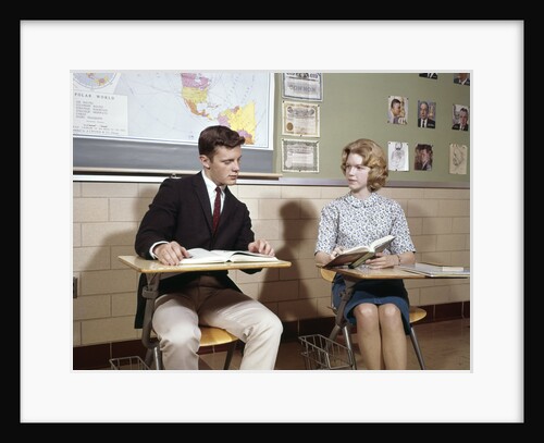 1960s Teenage Boy Girl Seated Classroom Desks Talking by Anonymous