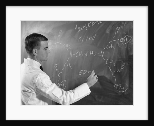 1960s Profile Of Scientist Man In Lab Coat Writing Out Chemical Formula On Blackboard by Anonymous