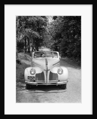 1940s 1941 Couple Man And Woman In Pontiac Convertible Driving On Country Lane In Countryside by Anonymous