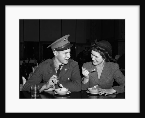 1940s Soldier In Army Uniform And Girlfriend Sitting At Soda Fountain Counter Eating Dish Of Ice Cream by Anonymous