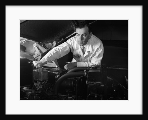 1950s Man Automotive Mechanic Servicing Car Engine by Anonymous