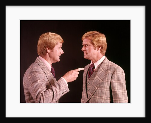 1970s Angry Red Haired Man In Plaid Suit Arguing With Himself by Anonymous
