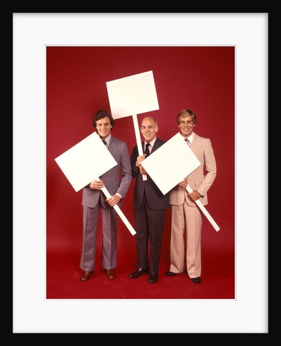 1970s Three Business Men Wearing Suits Each Carrying Blank Sign Placard Red Background by Anonymous