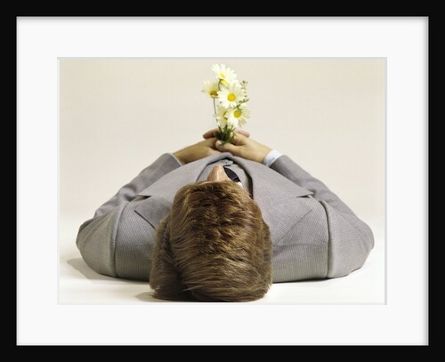 1970s Man Lying Down Pushing Up Daisies by Anonymous