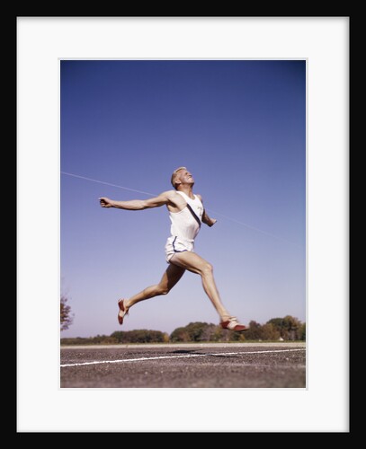 1960s Runner At Finish Line Breaking Through Tape by Anonymous