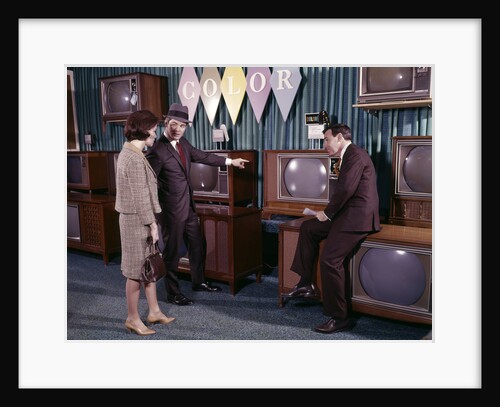 1960s Couple Man Woman Talking To Salesman In Color Television Set Sales Department by Anonymous