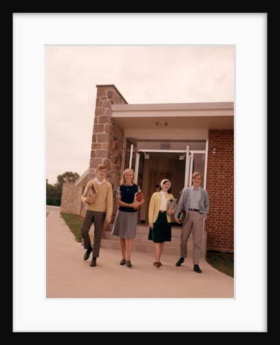 1960s Four Teenage Students Walking Out Of Suburban High School Building Carrying Books by Anonymous