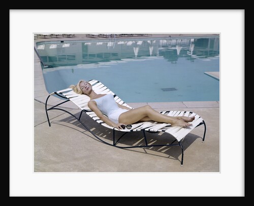 1960s Elegant Tall Woman In Bathing Suit Reclining On A Lounge Chair By Swimming Pool by Anonymous