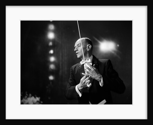 1960s 1970s Portrait Of Man In White Tie And Tails Conducting An Orchestra In Symphony Hall by Anonymous