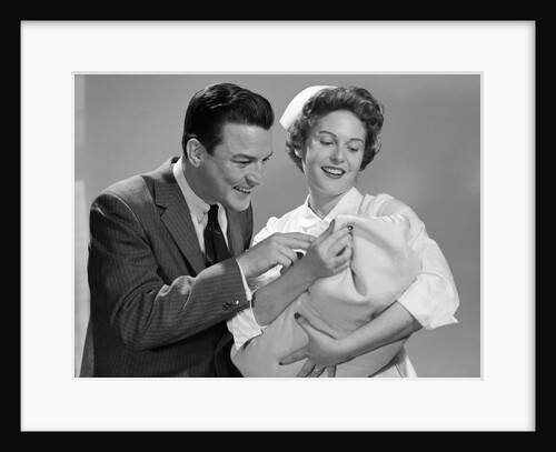 1950s 1960s Man New Father Looking At Baby Held By Woman Nurse by Anonymous