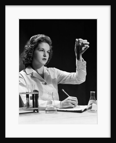 1940s Student Nurse Holding Up Test Tube While Taking Notes In Science Class by Anonymous