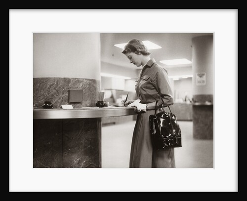 1950s 1960s Woman Handbag On Arm Gloves Filling Out Deposit Slip Bank Counter by Anonymous