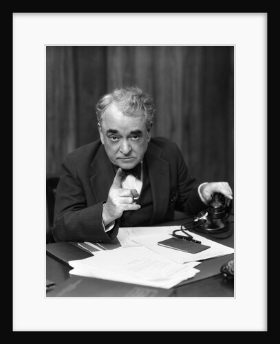 1930s Head-On Serious Senior Businessman Behind Desk Hand On Telephone Pointing by Anonymous