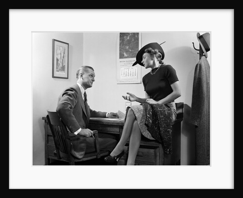 1940s Woman Sitting On Desk Hat Skirt Hand Gesture Talking Flirting With Man by Anonymous
