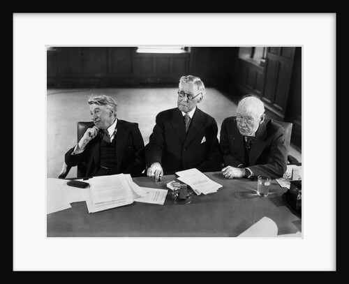 1930s 1940s Elderly Businessmen Sitting At Conference Table With Attention Directed To Speaker Not Shown by Anonymous