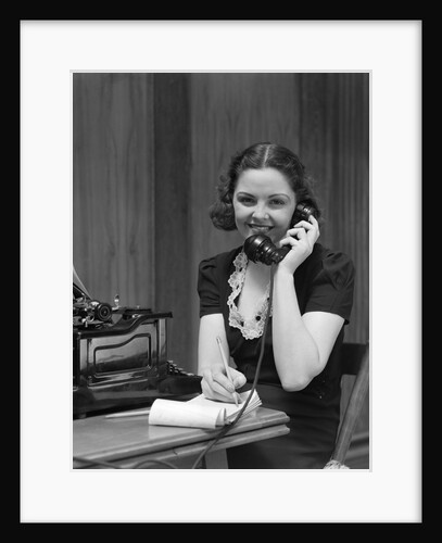1930s Woman Receptionist Secretary Sitting At Desk In Office Talking On Telephone by Anonymous