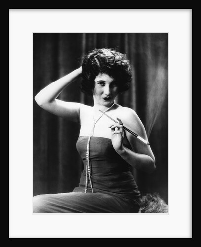 1920s Woman Wearing Strapless Gown String Pearls Holding Cigarette Holder Hand On Back Of Head by Anonymous