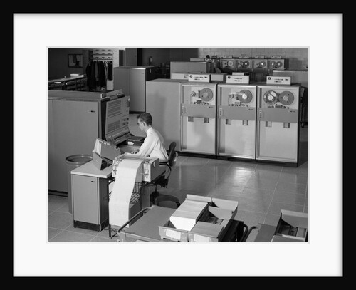 1960s Man Programming Large Mainframe Computer Surrounded By Data Tape Drives Indoor by Anonymous