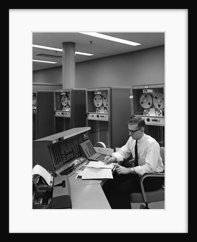 1960s Man In Shirt and Tie and Glasses At Control Console For Ibm Data Processing Systm by Anonymous