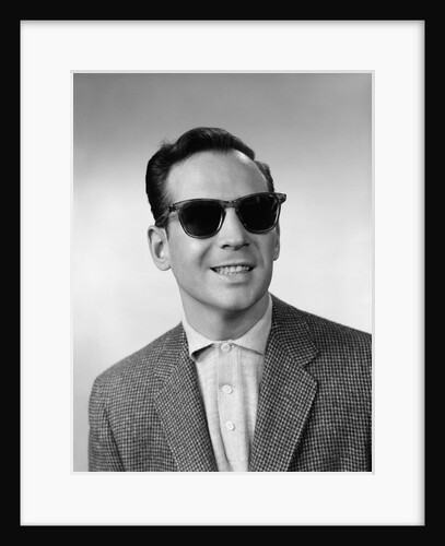 1950s 1960s Portrait Of Blind Man Wearing Sports Jacket Shirt And Very Dark Protective Sunglasses by Anonymous
