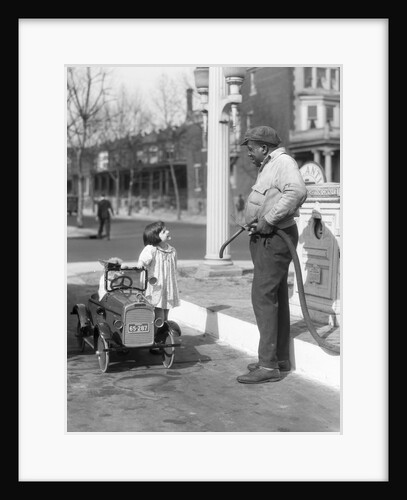 1920s Little Girl Standing Beside Her Pedal Car Asking For Gasoline by Anonymous