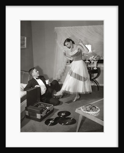 1950s 1960s Teen Couple Dressed for Prom, Girl Dancing To Music From A Record Player by Anonymous