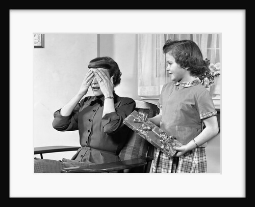 1950s Woman Mother Hands Covering Eyes As Girl Daughter Gives Her A Gift Present by Anonymous
