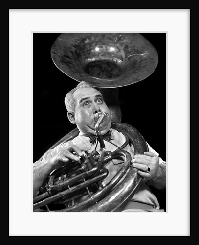 1940s Chubby Man Musician With Polka Dot Bow Tie And Bulging Eyes Playing A Sousaphone by Anonymous