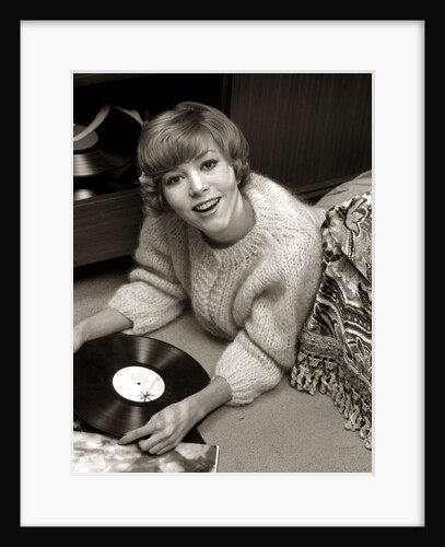 1960s Young Woman Sweater Lying On Bedroom Floor Listening To Music On Vinyl Record Album by Anonymous