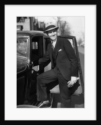 1930s Man In Suit And Hat Holding Gloves Stepping Into Automobile Driver Seat by Anonymous