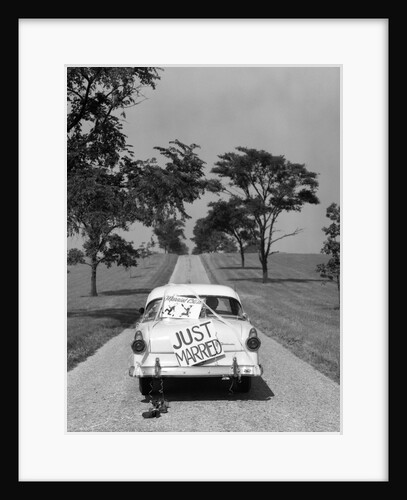 1950s Back Of White Ford Sedan Driving Off With Just Married Sign by Anonymous