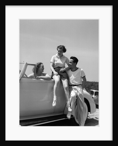 1930s Friends Sitting With Convertible Roadster Automobile Talking Together At Seashore by Anonymous
