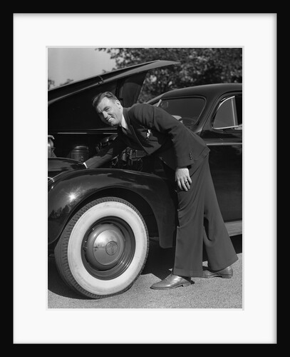 1939 1940s Man Wearing Suit And Tie Checking Engine Under Automobile Hood by Anonymous