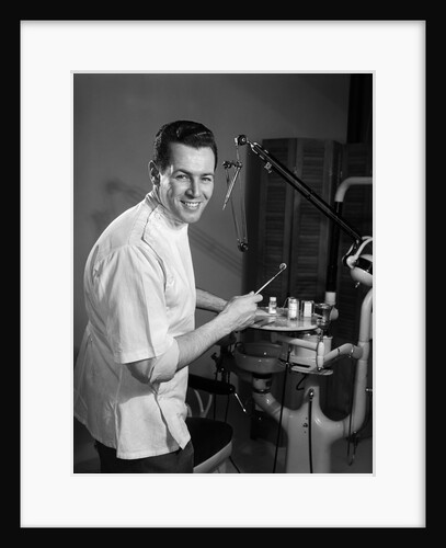 1960s Portrait Man Professional Dentist Holding Dental Tool Mirror by Anonymous