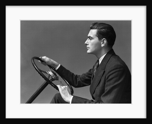 1930s 1940s Man Wearing Suit And Tie Holding Automobile Steering Wheel by Anonymous