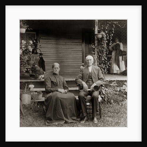1890s 1900s Portrait Senior Couple Seated In Garden Man Holding Ear Trumpet by Anonymous