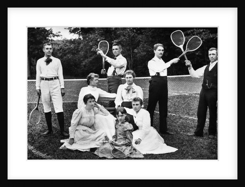 1890s 1900 Men Holding Racquets and Women and One Child In Front Of Net On Grass Tennis Court by Anonymous