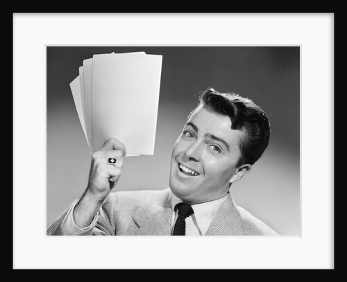 1950s Young Businessman Holding Up Handful Of Papers by Anonymous