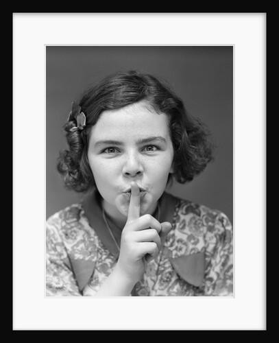1930s Portrait Of Young Girl With Finger To Mouth Making Shush Be Quiet Expression by Anonymous