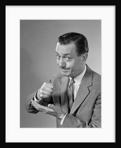 1960s Man Determined Businessman Serious Expression Pounding Fist Into Palm Of His Hand by Anonymous