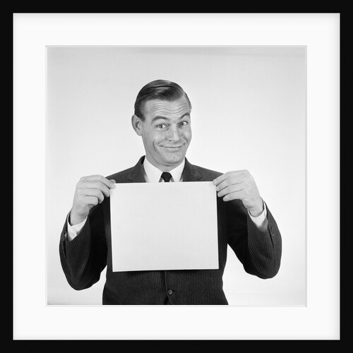 1950s 1960s Man Funny Facial Expression Holding Up Blank Empty Sheet Paper Placard Sign by Anonymous