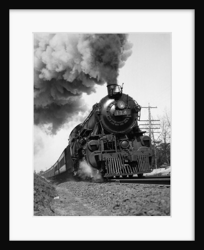 1920s 1930s Steam Engine Pulling Passenger Train Smoke Billowing From Exhaust Stack by Anonymous