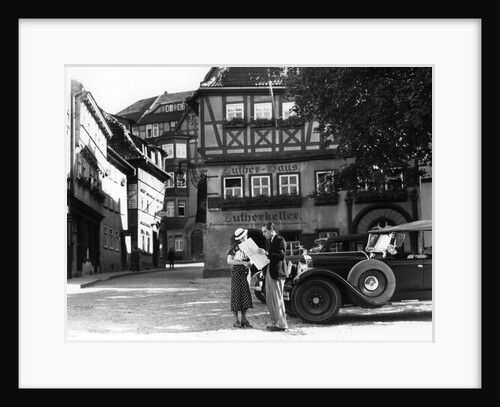 1930s Tourist Couple By Car Looking At Map In Front Of Eisenach Lutherhaus 1563 Where Luther Lived While Attending School by Anonymous