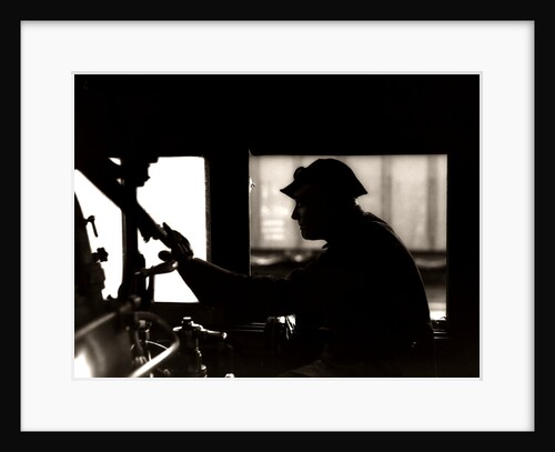 1920s 1930s 1940s Silhouette Train Engineer At Controls In Locomotive Cab Of Railroad Steam Engine by Anonymous