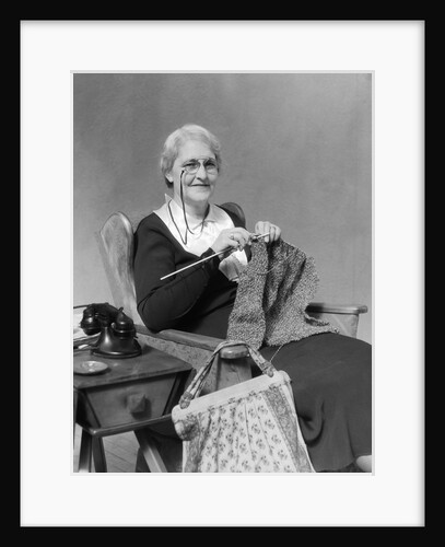1930s Elderly Woman Wearing Pince-Nez Glasses Sitting Knitting by Anonymous
