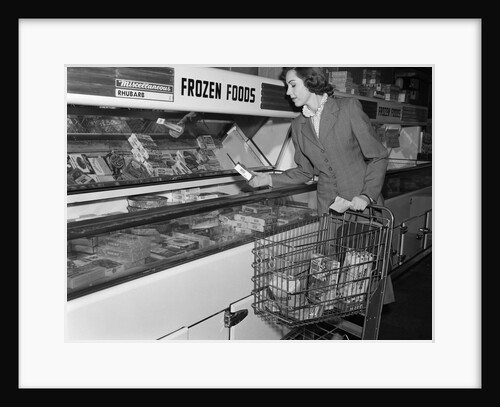 1950s Woman Shopping Frozen Food Section Of Grocery Store by Anonymous
