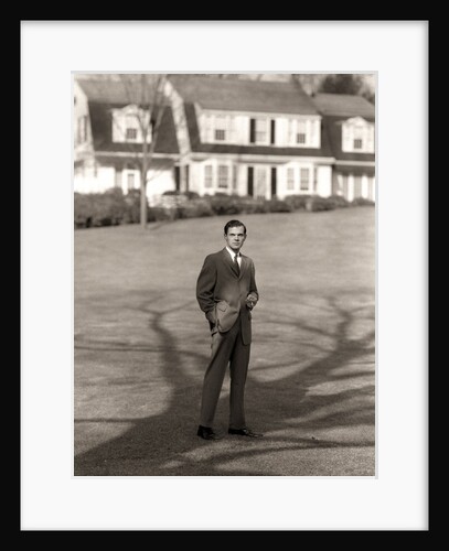 1950s Executive In Gray Flannel Suit And Tie Standing On Suburban Home Lawn by Anonymous